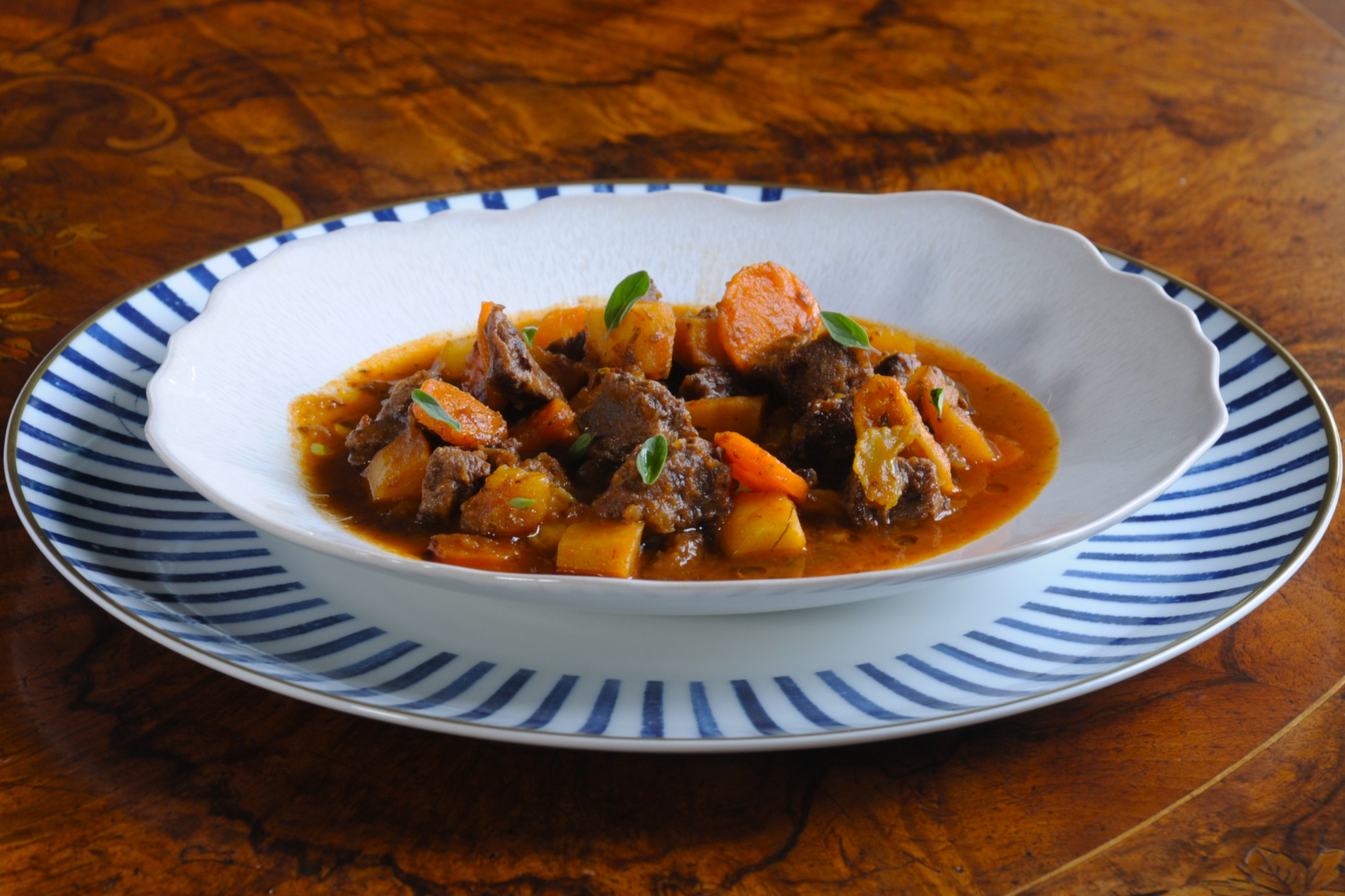 Slow-cooked beef cheek goulash plated and served by an Algarve chef, prepared for premium food delivery